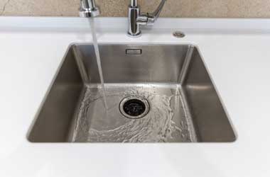 Empty Sink with the Faucet Turned On in Houston