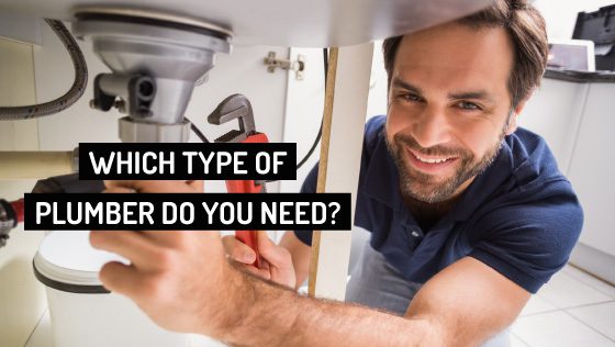 Smiling Professional Plumber Fixing Under-Sink Pipes